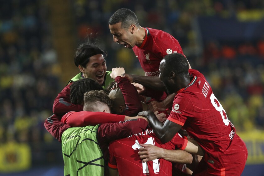 Liverpool's Fabinho celebrates with his teammates after scoring his side's opening goal during the Champions League semi final, second leg soccer match between Villarreal and Liverpool at the Ceramica stadium in Villarreal, Spain, Tuesday, May 3, 2022. (AP Photo/Alberto Saiz)