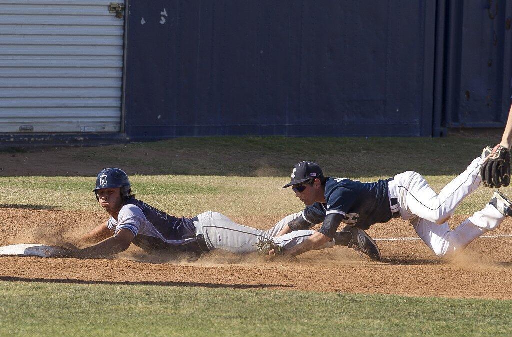 Newport Harbor High's Dylan Kaplan runs down Marina's Joseph Waked after being caught in a pickle during a Sunset League game on Wednesday.