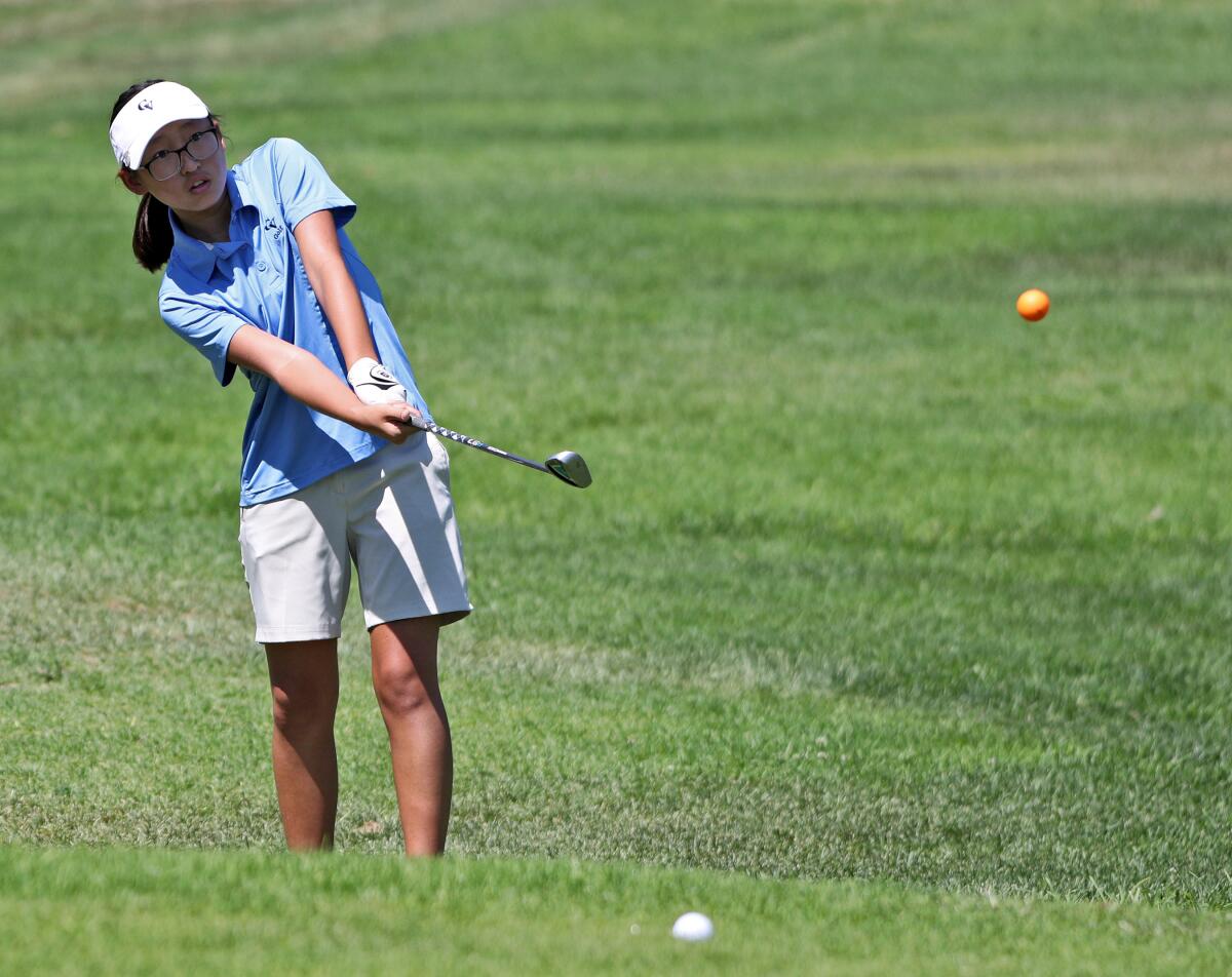 Crescenta Valley High School golfer Katie Bernabe chips towards the green during Pacific League golf match at Altadena Golf Course in Altadena on Wednesday, Sept. 4, 2019.