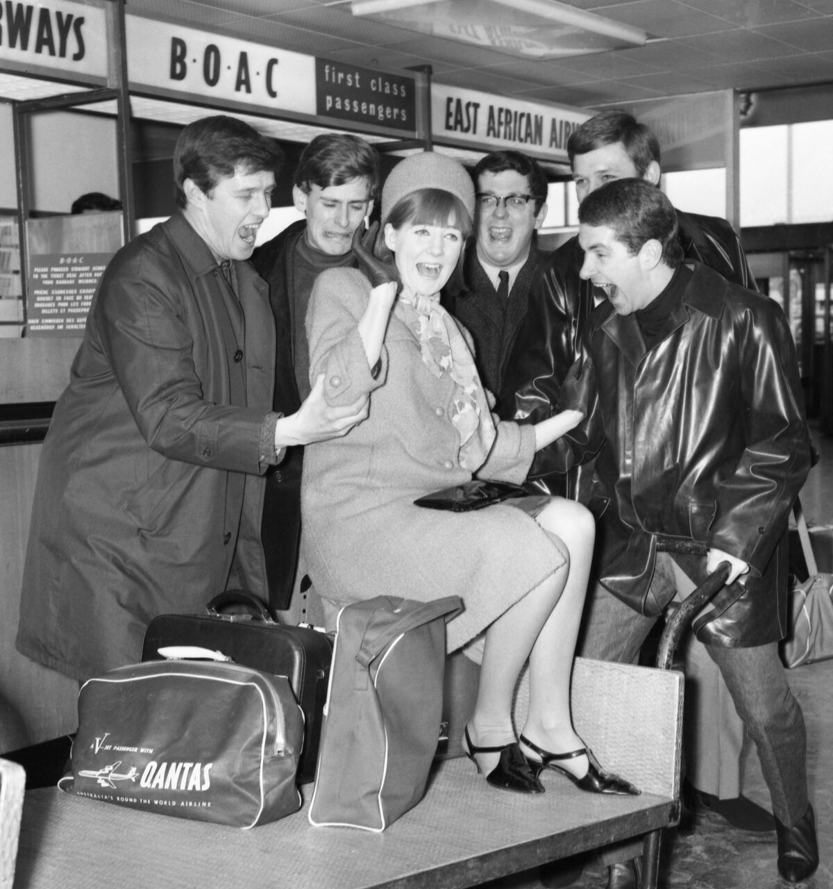 Singer Cilla Black laughs with members of the Sounds Incorporated on March 3, 1965.