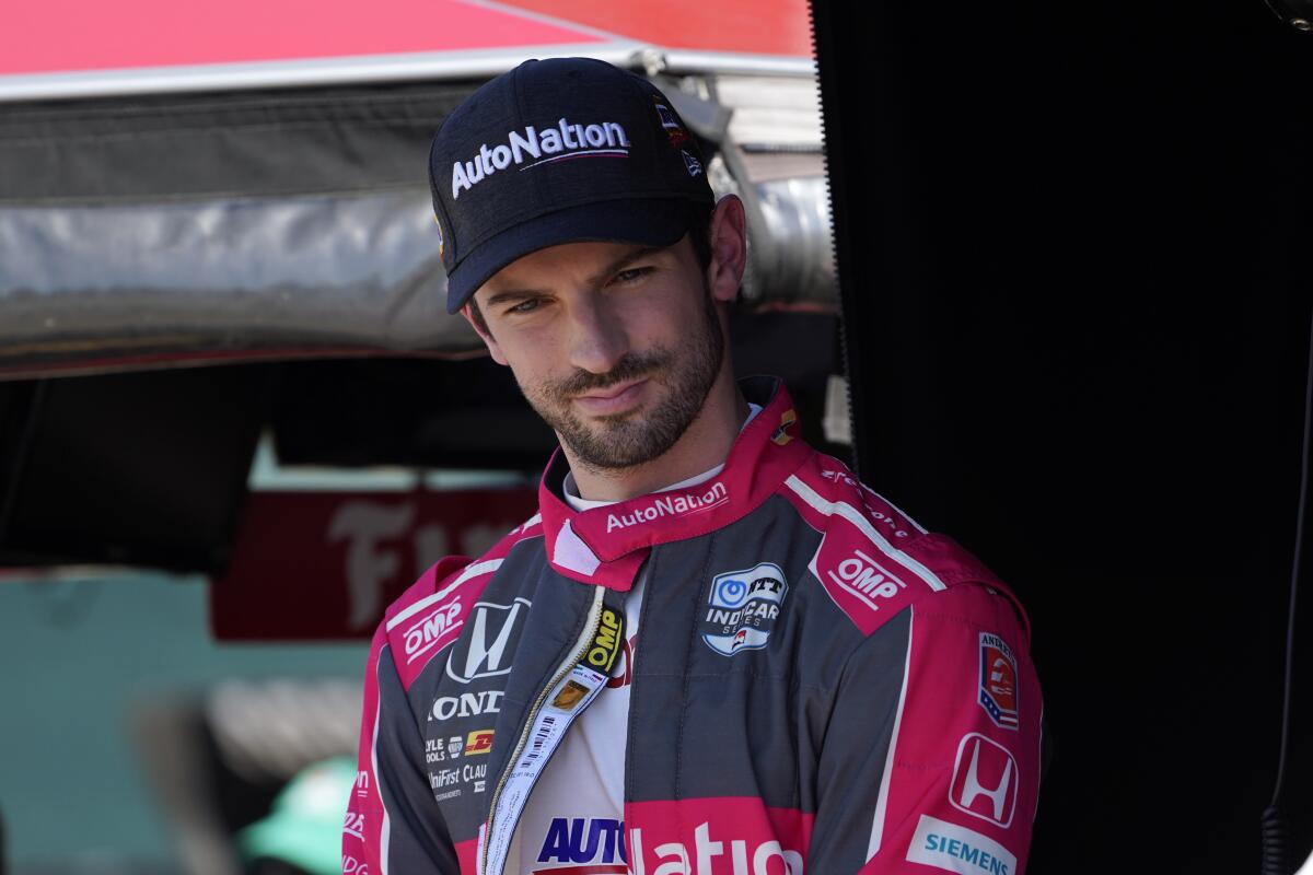 FILE - Alexander Rossi waits before practice for the IndyCar Detroit Grand Prix auto racing doubleheader on Belle Isle in Detroit, Friday, June 11, 2021. Rossi closed out his 2021 racing season with a class victory in the off-road Baja 1000 to bookend his year with big wins. But his eyes are on the upcoming IndyCar season and the final year of his contract with Andretti Autosport. Rossi has not won an IndyCar race since 2019. (AP Photo/Paul Sancya, File)