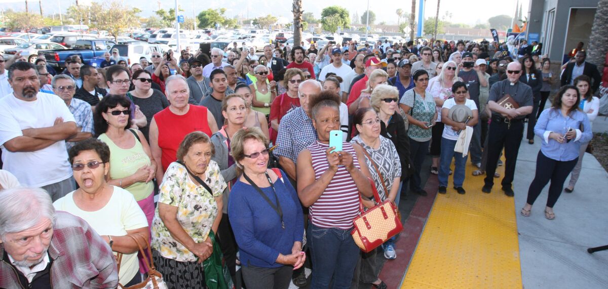 Hundreds of soon-to-be Walmart shoppers watch a short ceremony marking the opening of the new megastore on N. Victory Place in Burbank on Wednesday, June 22, 2016.