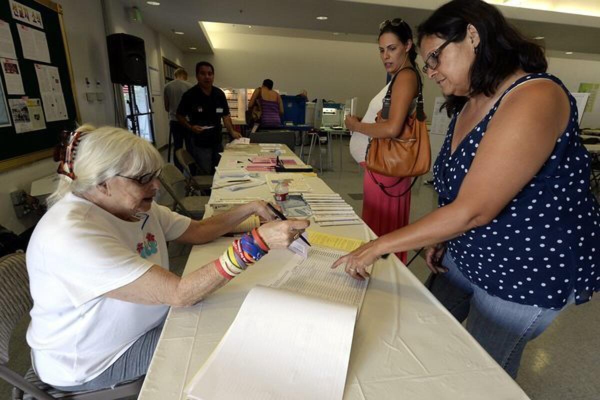 The U.S. Senate passed a bipartisan immigration bill that has moved to the GOP-controlled House. Above: Latino voters Ana-Maria Baneulos, middle, and her mother Debbie Burruel, right, prepare to vote at a polling station in the San Fernando Valley.