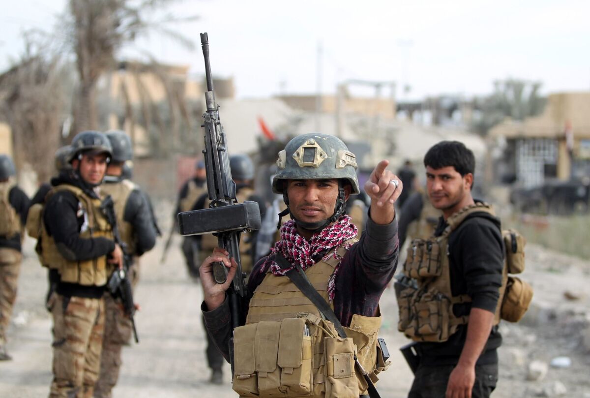 Members of Iraq's Counter-Terrorism Service secure a neighborhood in Ramadi on Dec. 27.