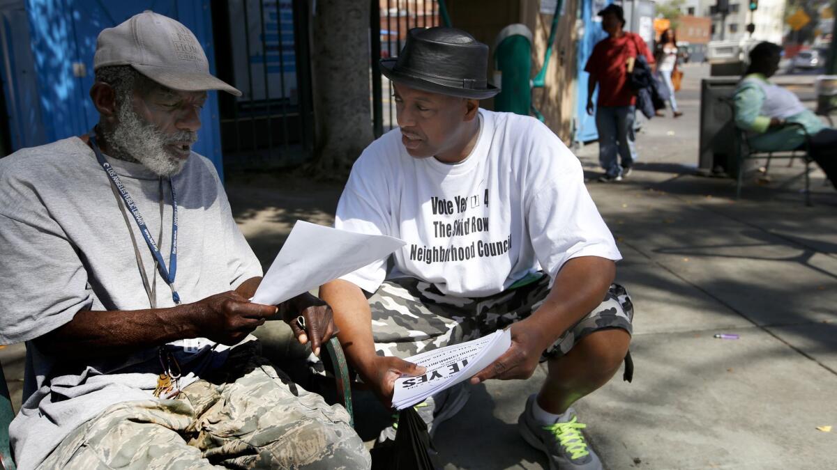 LOS ANGLES, CA APRIL 5, 2017: General Jeff Page, right, speaks with Terry Prescod, left, at in Gladys Park in the skid row area of Los Angles, Ca April 5, 2017. He is an organizer of the proposed skid row neighborhood council. (Francine Orr/ Los Angeles Times)