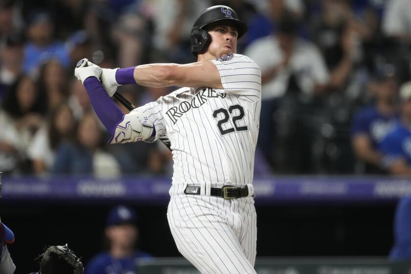 Colorado Rockies' Nolan Jones watches his two-run double against the Los Angeles Dodgers during the fourth inning of a baseball game Thursday, Sept. 28, 2023, in Denver. (AP Photo/David Zalubowski)