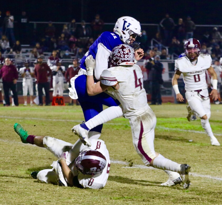 Venice quarterback Paul Kessler is tackled by Independence linebacker Evan Peaker during the first half Friday night.