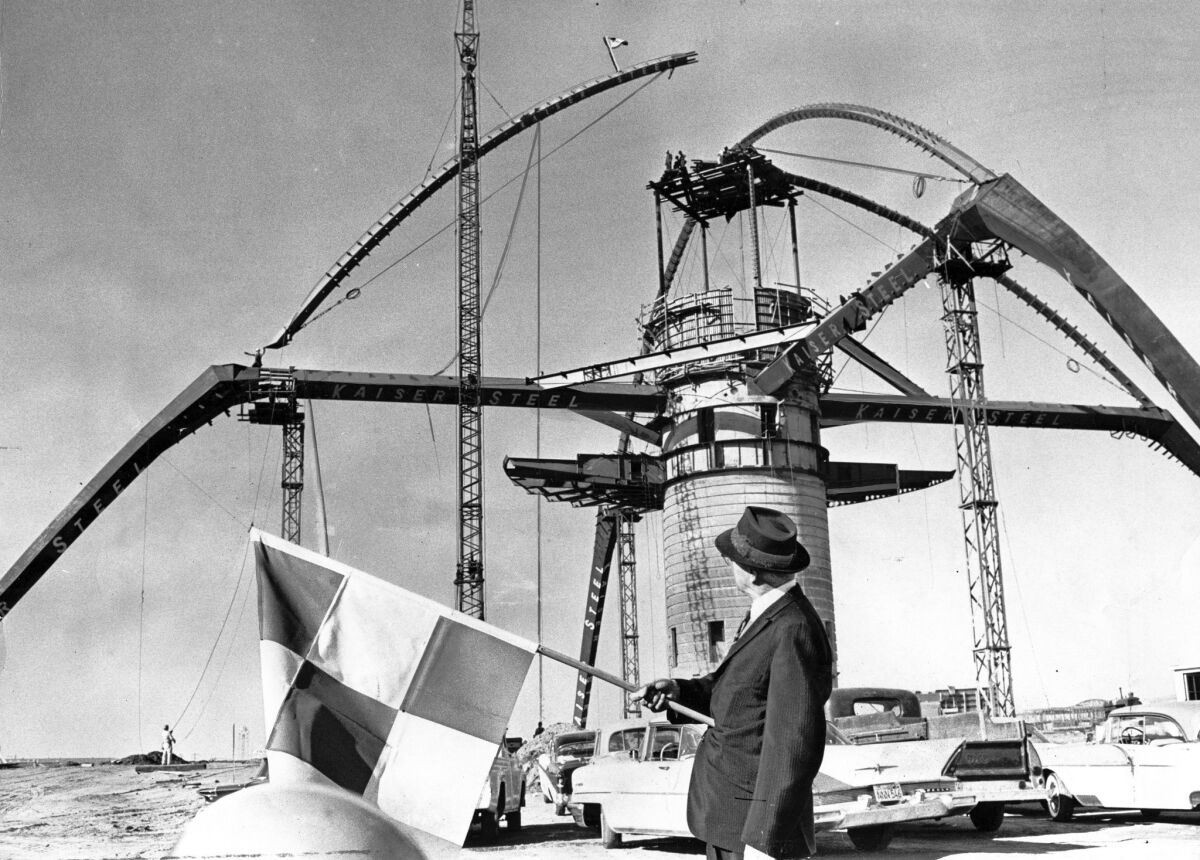 The last girder is placed on the arch of the LAX Theme Building, designed by architect Paul Revere Williams.