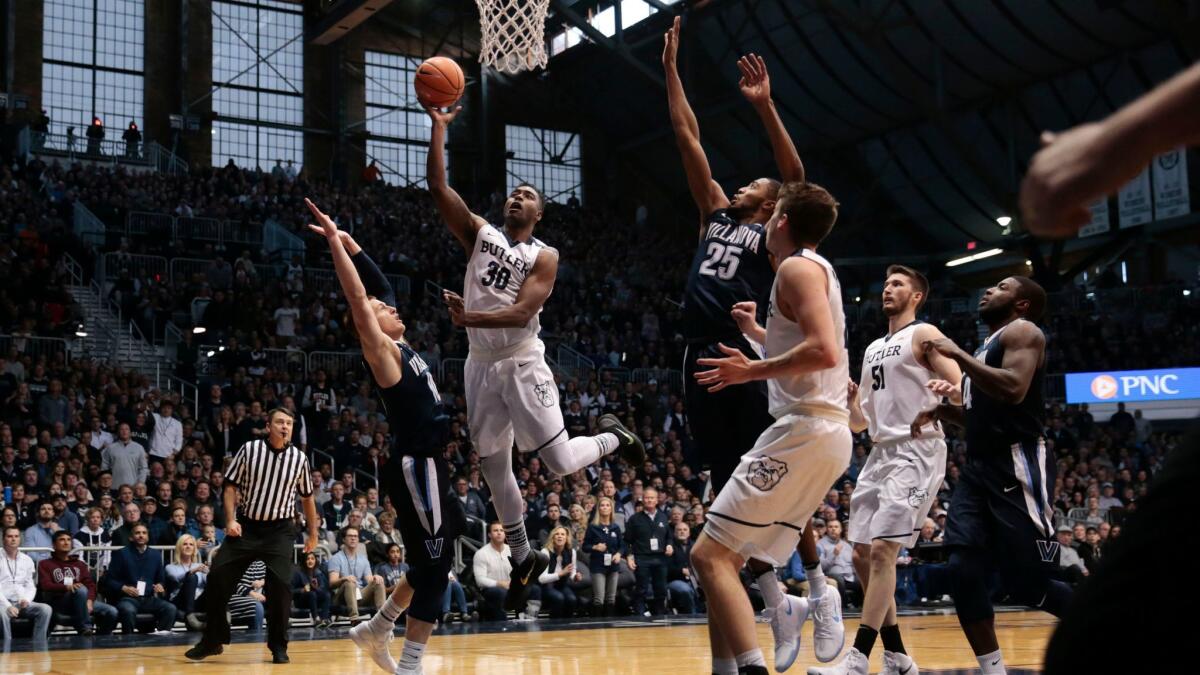 Butler forward Kelan Martin (30) shoots between Villanova defenders Donte DiVincenzo (left) and Mikal Bridges (25) in the first half.