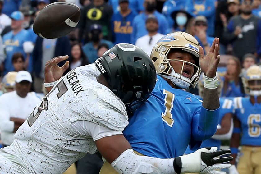 PASADENA, CALIF. - OCT. 23, 2021. UCLA quarterback Dorian Thompson-Robinson loses control of the ball.