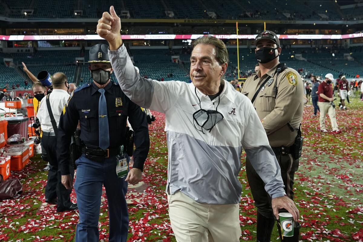 Alabama head coach Nick Saban gives a thumbs-up as he leaves the field after a victory.