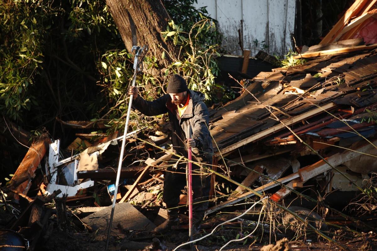 A man who asked to be identified only as Mikey, sifts through mud and debris looking for his girlfriend's two missing sisters: Morgan Corey and Sawyer Corey. He said their house on Sycamore Canyon Road was swept away.