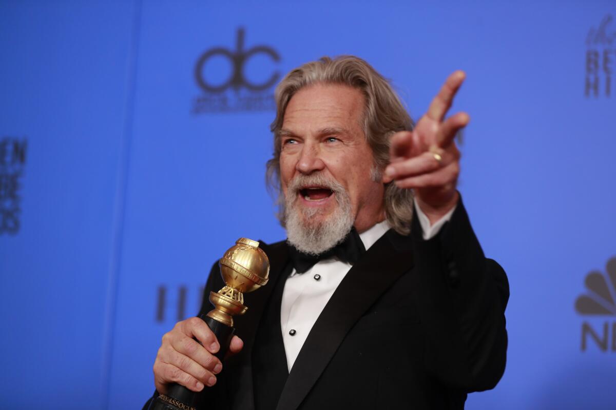Jeff Bridges poses backstage with his Cecil B. DeMille Award.