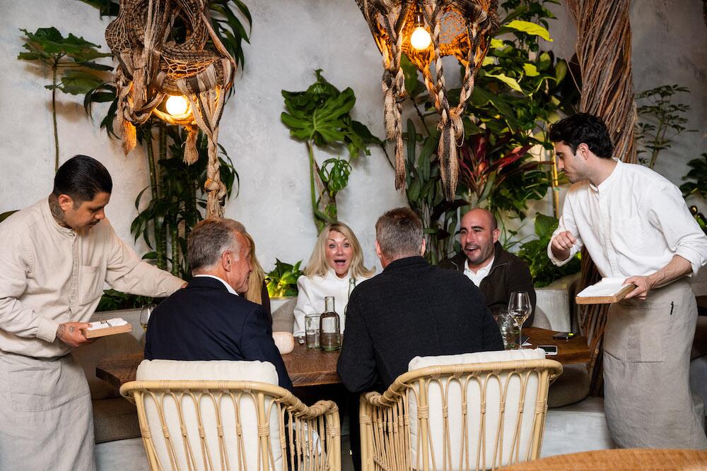 (from left) Drew Fenton of Carolwood Estates, Jade Mills and Tom Dunlap of Coldwell Banker and Justin Huchel of Carolwood Estates share a story prior to dinner.