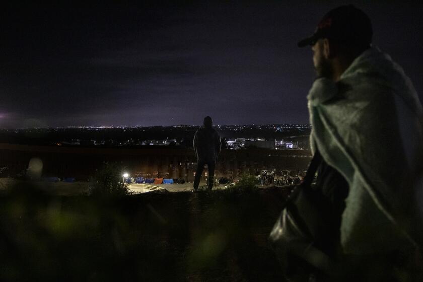 Tijuana , Baja California - May 11: More than 200 migrants wait between the border walls that separate Tijuana from San Diego as Title 42 ends on Thursday, May 11, 2023 in Tijuana , Baja California. (Ana Ramirez / The San Diego Union-Tribune)