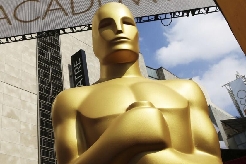 FILE - In this Feb. 21, 2015 file photo, an Oscar statue appears outside the Dolby Theatre for the 87th Academy Awards in Los Angeles. The Oscars are adding a new category to honor popular films and promising a brisk 3-hour ceremony on a much earlier air date of Feb. 9, 2020. (Photo by Matt Sayles/Invision/AP, File)