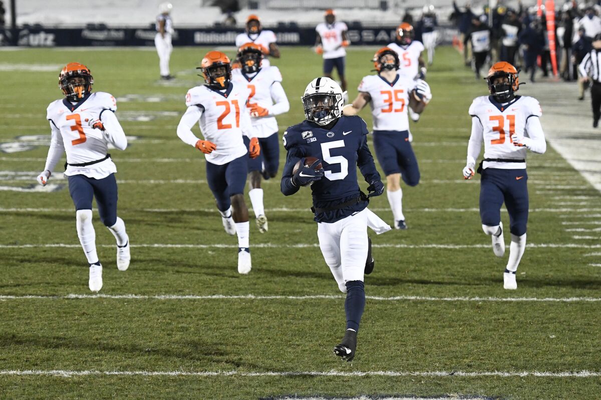 FILE - In this Dec. 19, 2020, file photo, Penn State wide receiver Jahan Dotson (5) scores a touchdown on a 75-yard pass in the first quarter of an NCAA college football game against Illinois in State College, Pa. Dotson opted to return for his final season for a number of reasons. He wanted to get bigger, faster and stronger. He also wanted to help the program re-establish itself as an offensive powerhouse after a disappointing 2020 (AP Photo/Barry Reeger, File)