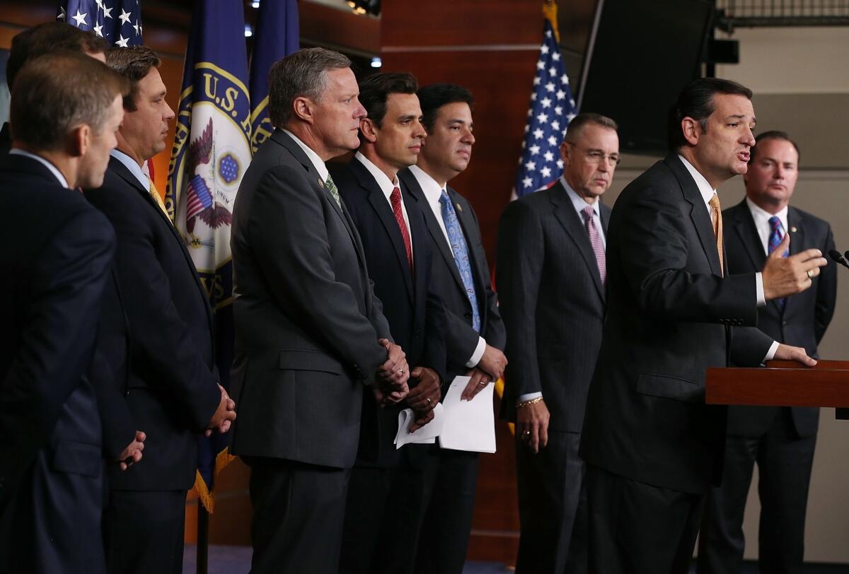 Sen. Ted Cruz (R-Texas) is flanked by House Republicans as he discusses the Affordable Care Act at a news conference in Washington.