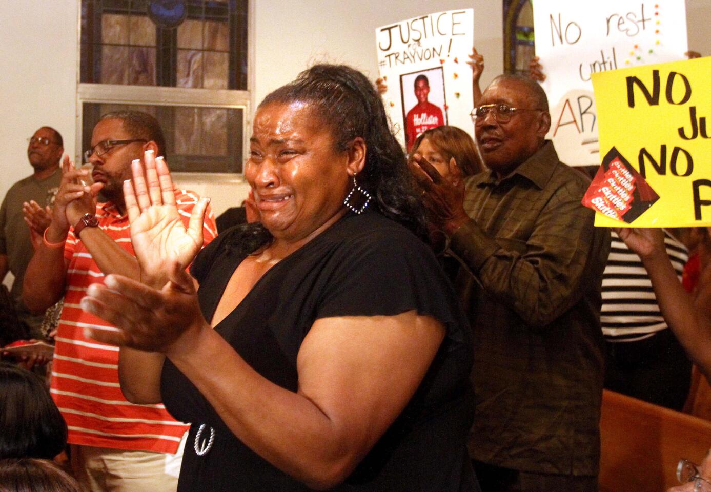 Resident Cindy Philemon cries as protesters inside the Allen Chapel AME Church in Sanford, Fla., Tuesday night, March 20, 2012, rally where a meeting hosted by the NAACP was being held to address community concerns in the shooting of Trayvon Martin. Complete coverage of the Trayvon Martin case
