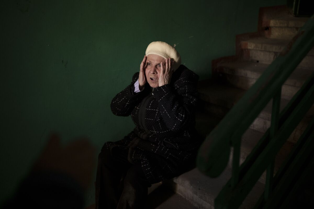 A woman reacts next to the body of a 15-year-old boy killed during a Russian attack in Kharkiv, Ukraine, Friday, April 15, 2022. (AP Photo/Felipe Dana)