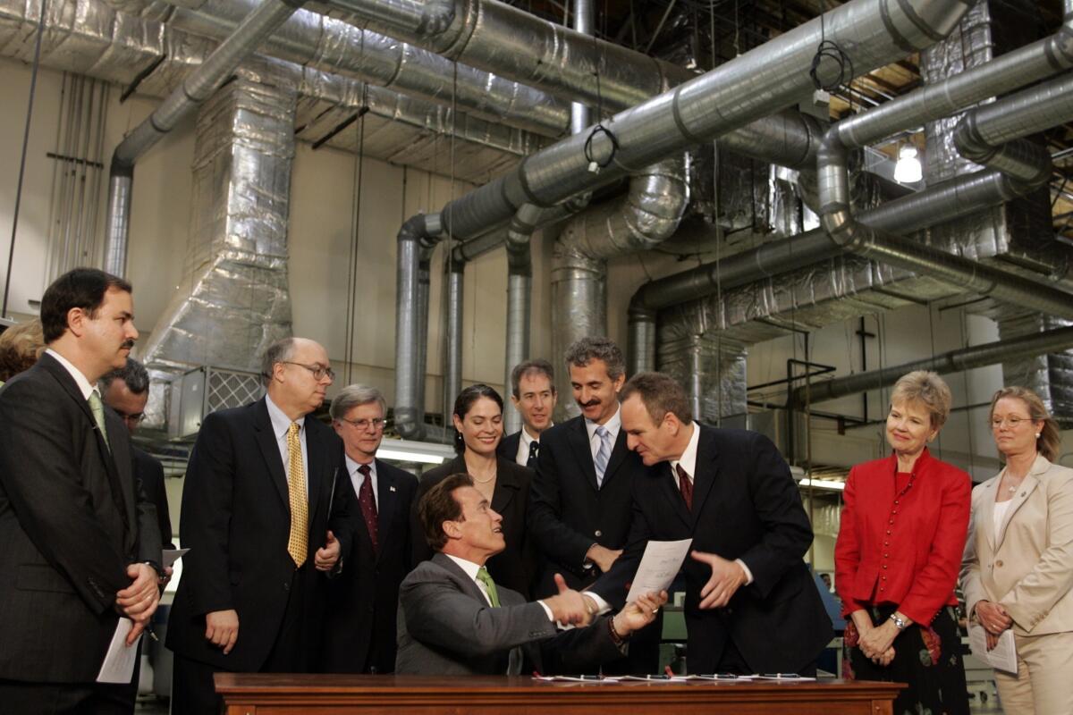 Then-Gov. Arnold Schwarzenegger, surrounded by members of California's Assembly and Senate, is shown after signing legislation to control toxic chemicals in 2008.