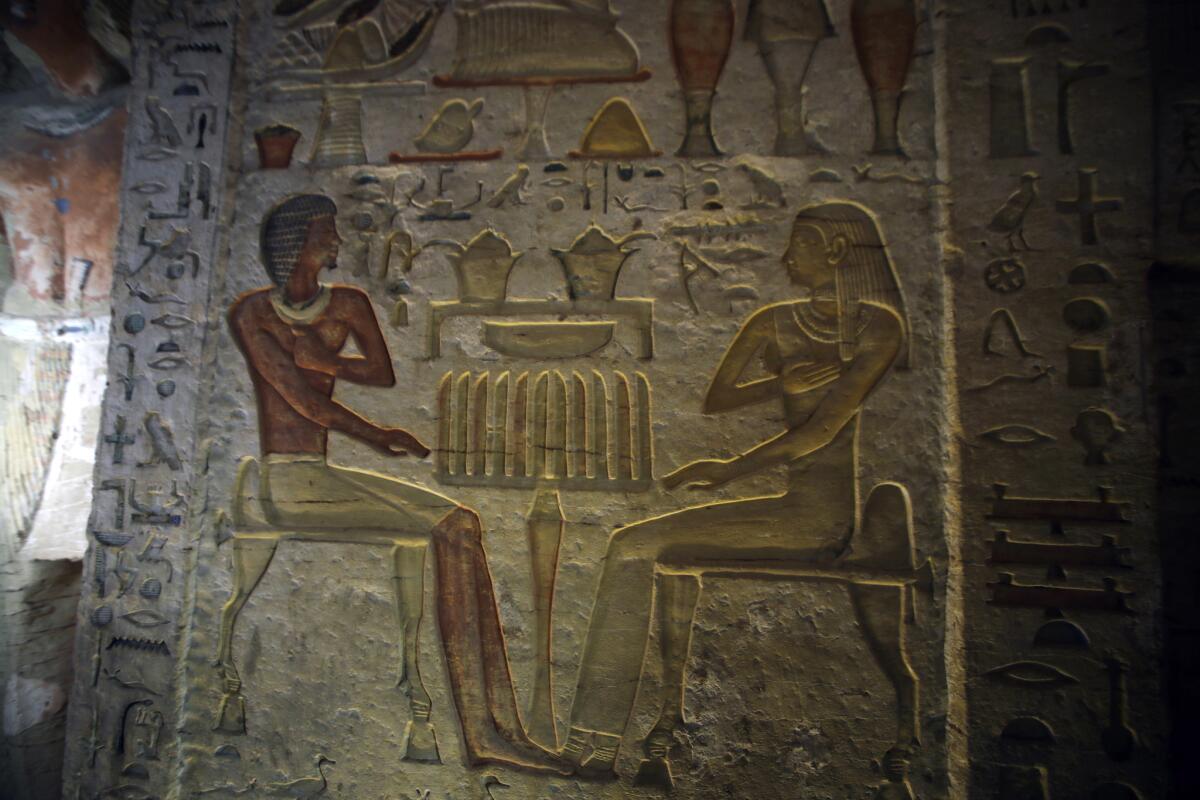 Colored scenes depict the high priest Wahtye and his family in the tomb in Saqqara, south of Cairo.