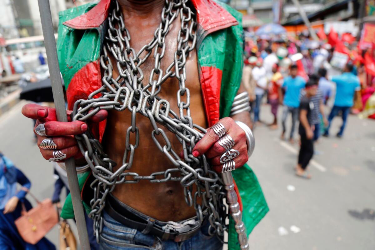 In Bangladesh, a demonstrator wears chains as workers organization members take part in a May 1 protest.