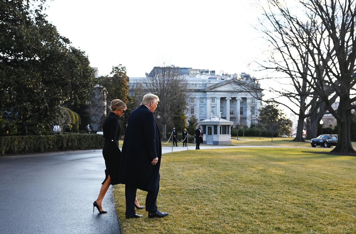 President Trump and First Lady Melania Trump head for Marine One, departing the White House for the last time Wednesday.
