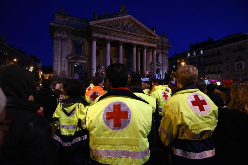 Emergency personnel attend a tribute to victims of the Brussels attacks on the Place de la Bourse in central Brussels.