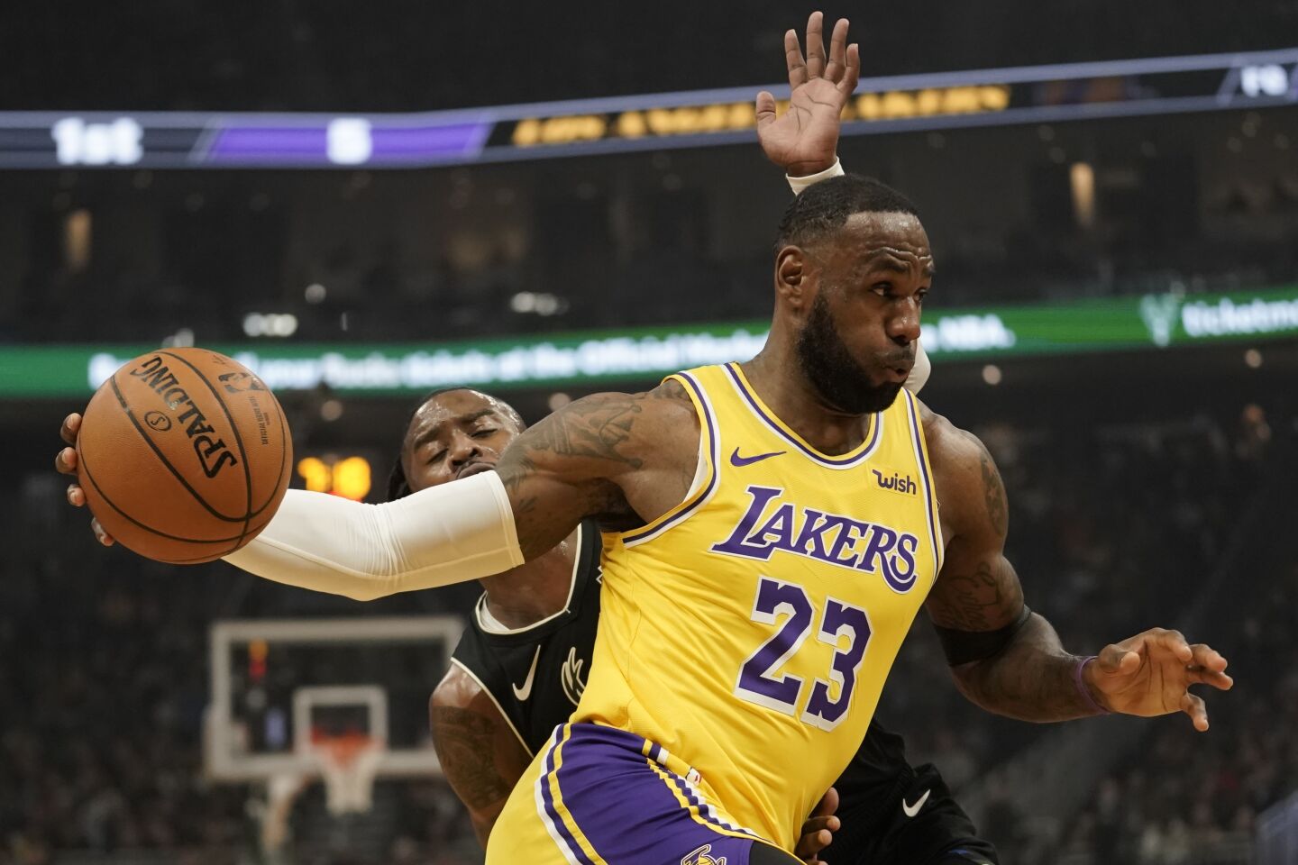 Lakers forward LeBron James drives past Bucks guard Wesley Matthews during the first half of a game Dec. 19.