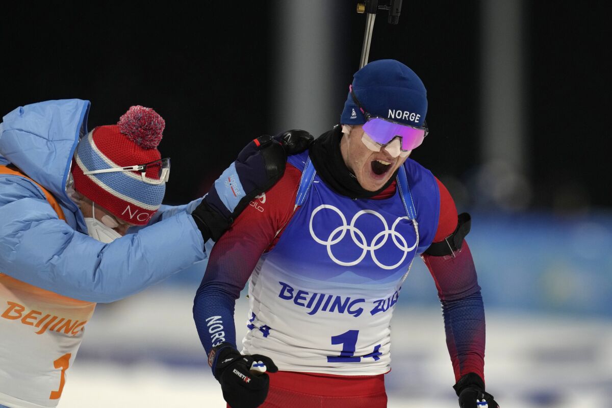 Johannes Thingnes Boe of Norway reacts after winning the biathlon 4x6-kilometer mixed relay at the 2022 Winter Olympics, Saturday, Feb. 5, 2022, in Zhangjiakou, China. (AP Photo/Kirsty Wigglesworth)