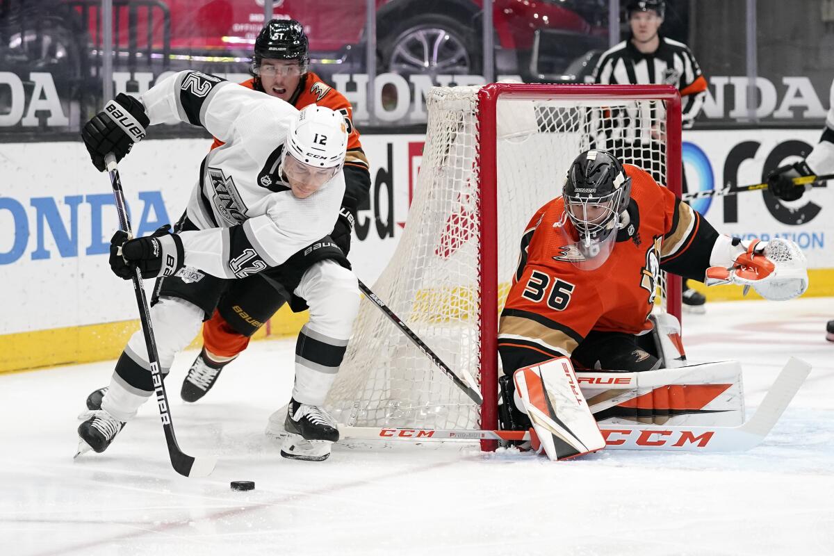 Los Angeles Kings center Trevor Moore, left, tries to get a shot past Anaheim Ducks goaltender John Gibson.