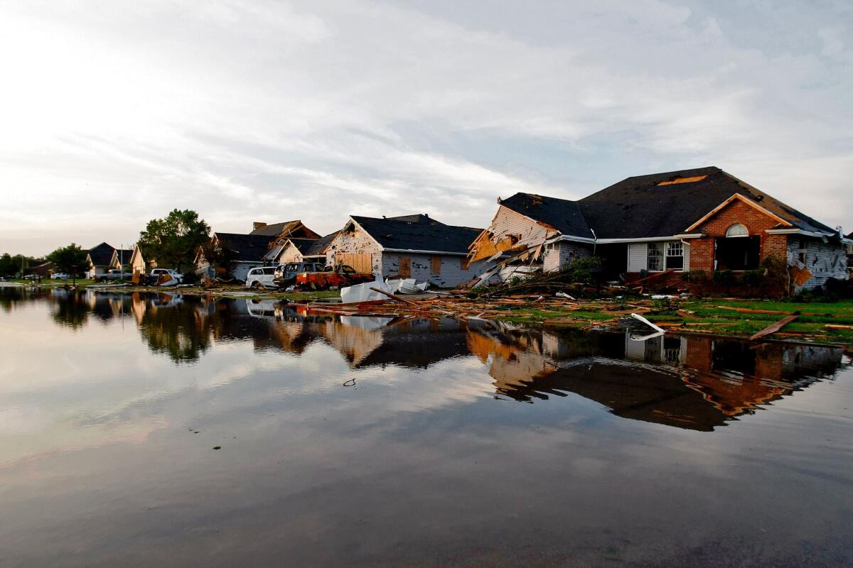A view of a flooded street and damaged homes June 23, the day after a storm including a tornado struck, in Coal City, Ill.