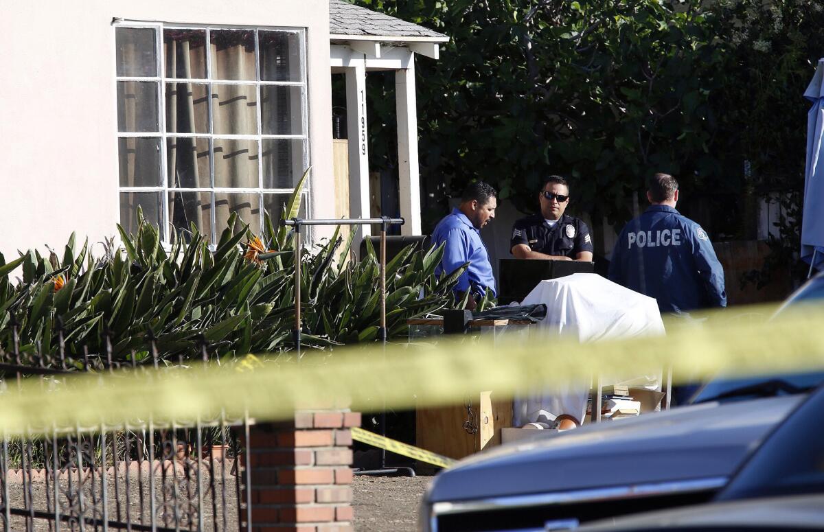 Authorities investigate Monday in the Del Rey neighborhood of Los Angeles after an 8-year-old boy was shot in the head by a stray bullet while he was sleeping late Sunday night.