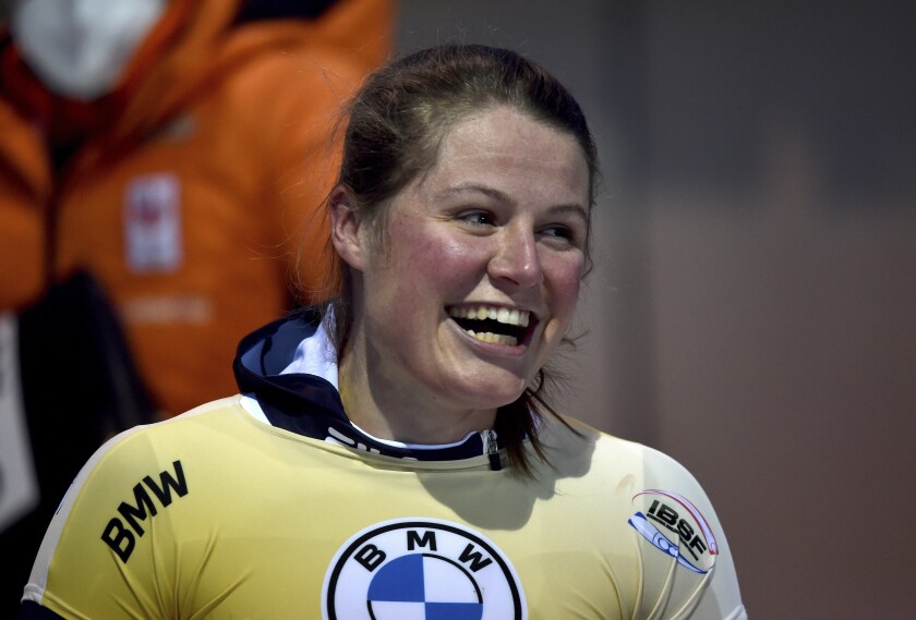 Kimberley Bos from the Netherlands smiles after her first place in the women's skeleton world cup in Winterberg, Germany, Friday, Jan. 7, 2022. (Caroline Seidel/dpa via AP)