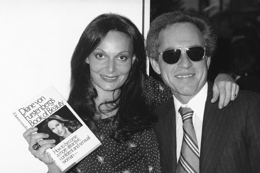 Former Princess Diane von Furstenburg posing with of Simon & Schuster executive Richard Snyder on Feb. 28, 1977 celebrating the publication of her new book on beauty. Snyder, a visionary and imperious executive at Simon & Schuster who presided over the publisher’s exponential rise over the past half century and helped define an era of growing corporate power, died on Tuesday at his home in Los Angeles at age 90. (AP Photo/RFS, File)
