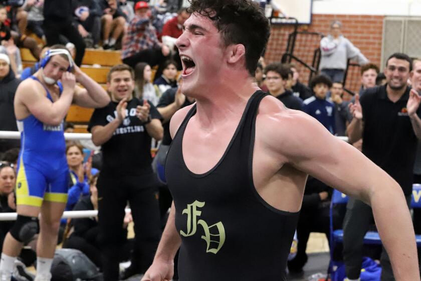 Fountain Valley's Khale McDonell yells out after winning in his weight class wrestling match.