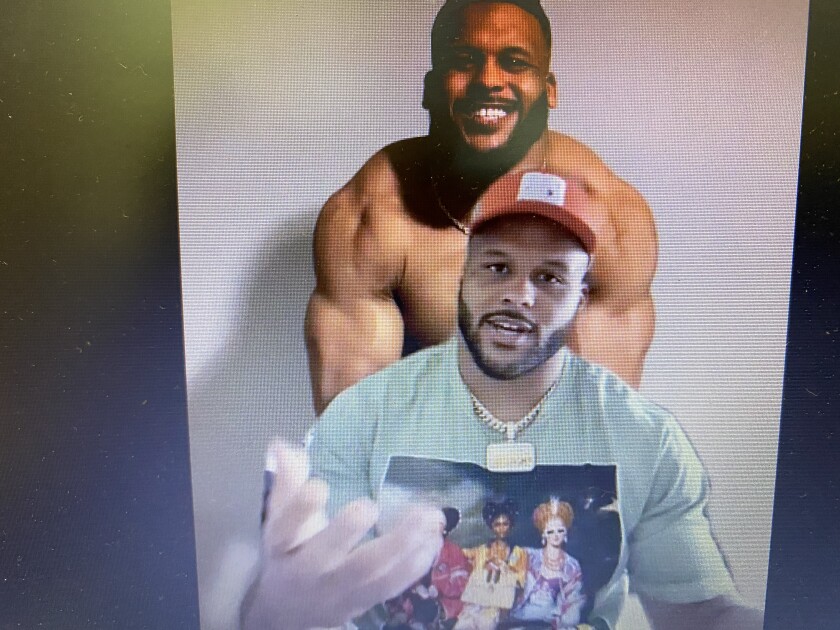 Rams defensive tackle Aaron Donald speaks on a zoom conference call, with a photo of himself flexing as his background. 