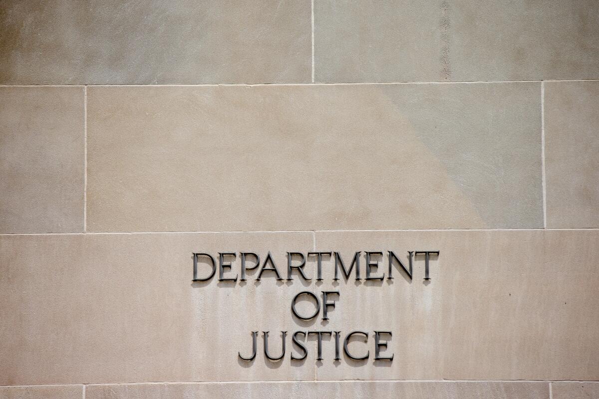 A close-up view of the words 'Department of Justice' on the DOJ building in D.C.