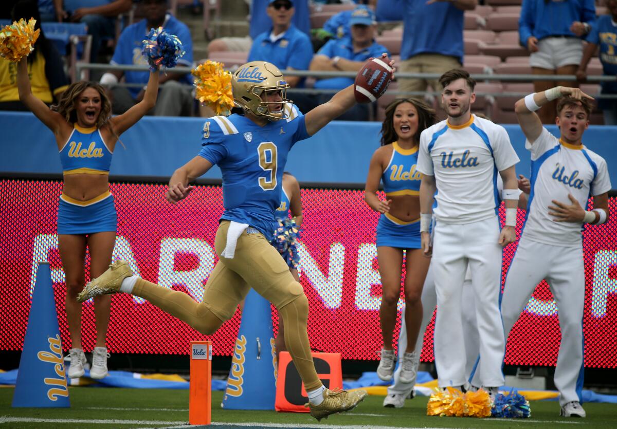 UCLA quarterback Collin Schlee scores a touchdown in the first quarter of the Bruins' win over North Carolina Central.