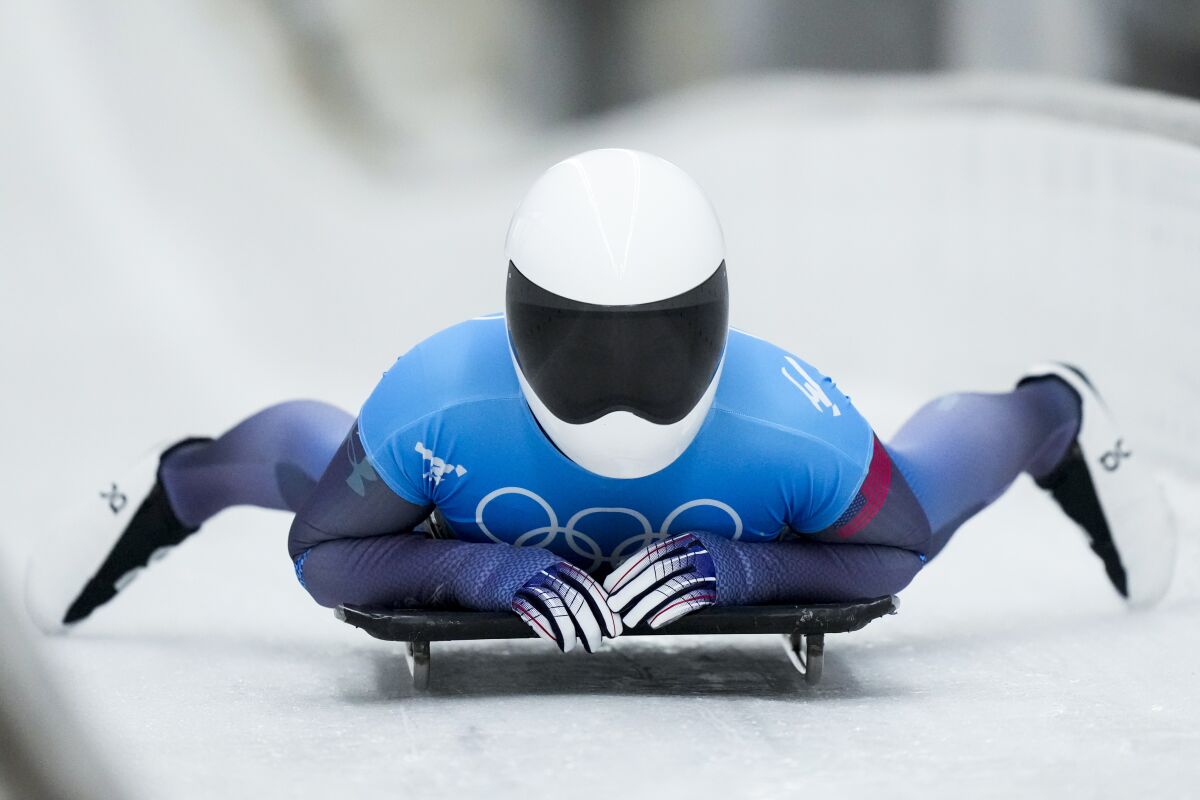 Kelly Curtis, of United States, finishes the women's skeleton run 2 at the 2022 Winter Olympics, Friday, Feb. 11, 2022, in the Yanqing district of Beijing. (AP Photo/Mark Schiefelbein)