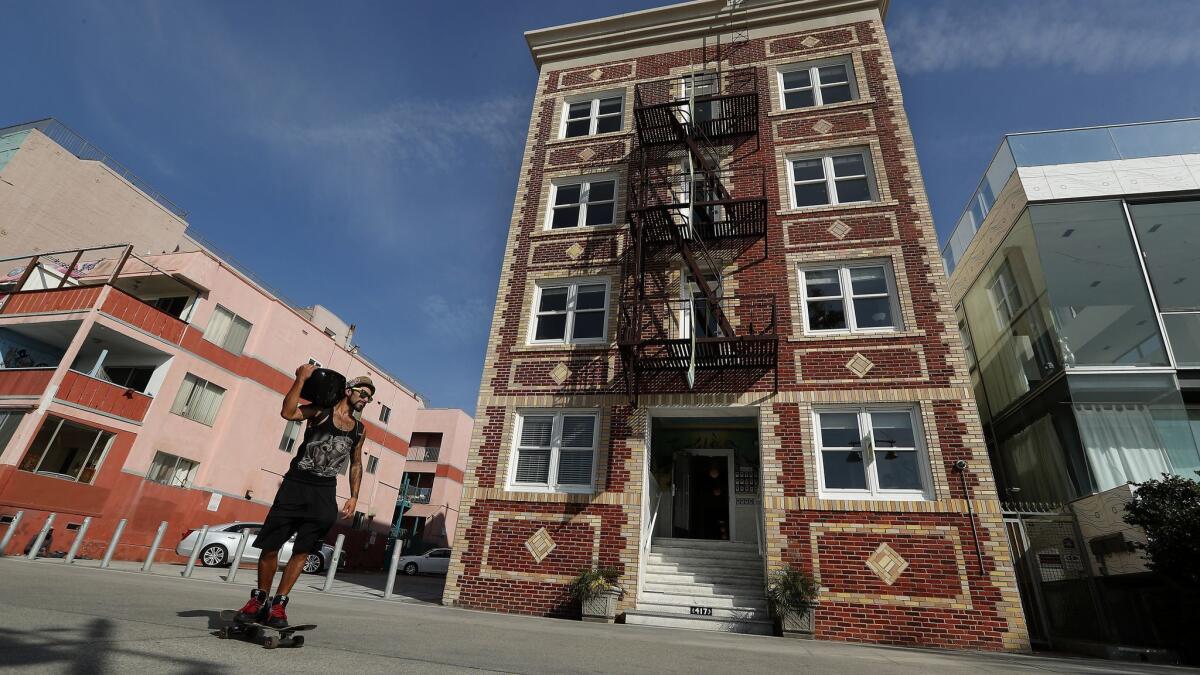 An Ocean Front Walk building, center, has been the focus of a civil suit from City Atty. Mike Feuer. A Los Angeles Superior Court judge ruled Friday that renting out units in the building for short stays was not banned under city codes.