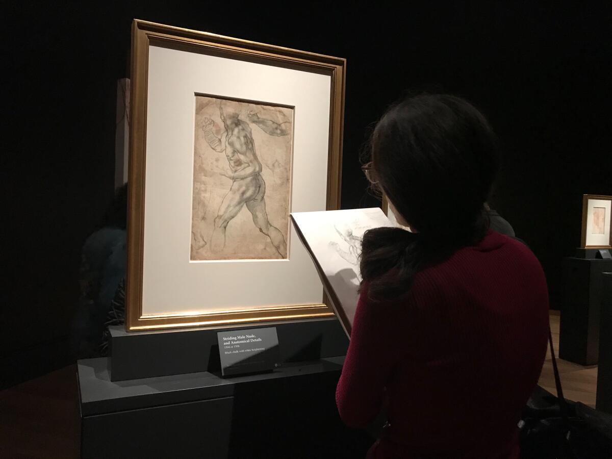 Lala Ragimov sketches a drawing by Michelangelo at the Getty Museum on Friday. An artist and gem carver, she rushed to see the exhibit before the museum closed due to coronavirus concerns.