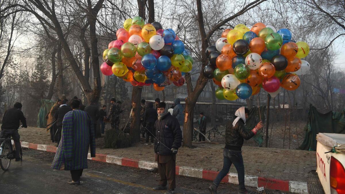 Street vendors sell balloons at the site of Thursday's suicide attack in Kabul, Afghanistan.
