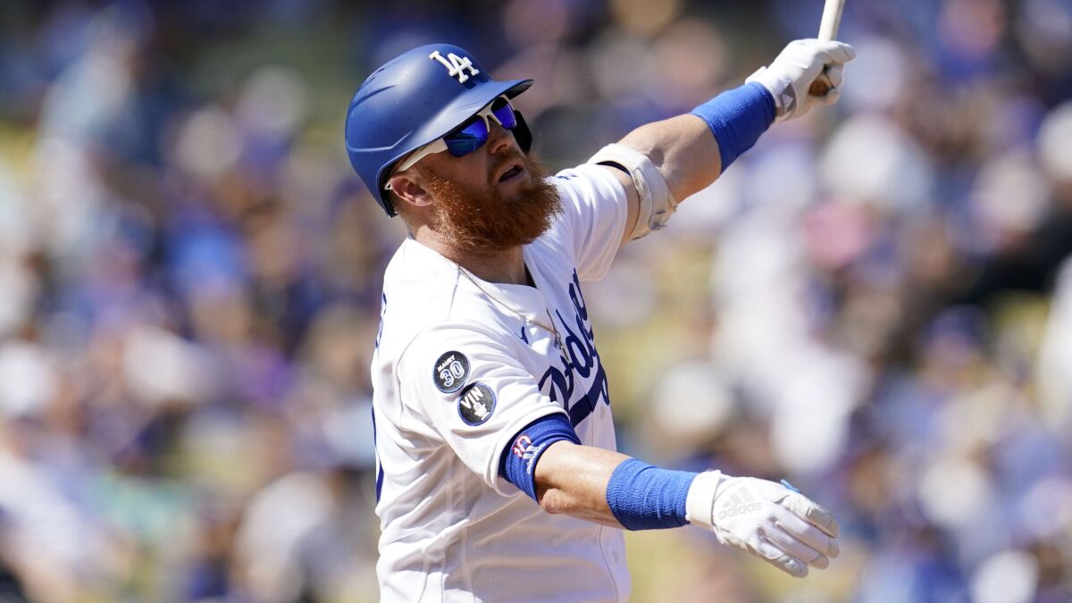 Dodgers' Justin Turner hits during a game against the Colorado Rockies.