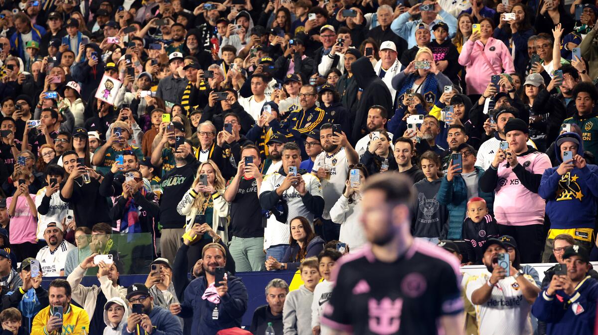 Fans take pictures and video as Inter Miami's Lionel Messi prepares for a corner kick against the Galaxy.
