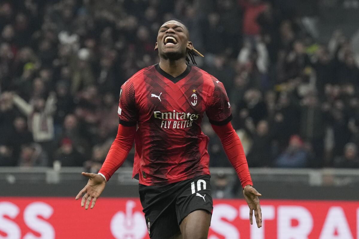 AC Milan's Rafael Leao celebrates after scoring his side's third goal during the Europa League play-off first leg soccer match between AC Milan and Rennes at the San Siro Stadium, in Milan, Italy, Thursday, Feb. 15, 2024. (AP Photo/Antonio Calanni)