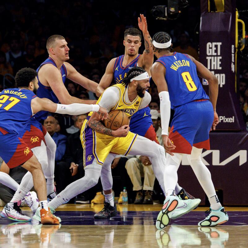 Lakers forward Anthony Davis (3) is swarmed by Nuggets while trying to hold onto the ball