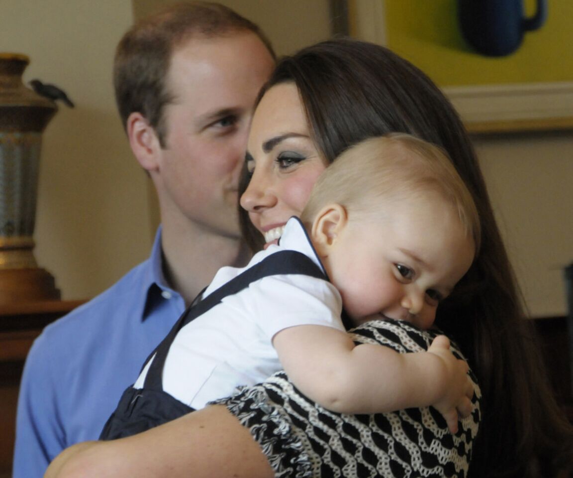 Prince William, Catherine and Prince George visit a group of other new parents at Government House.
