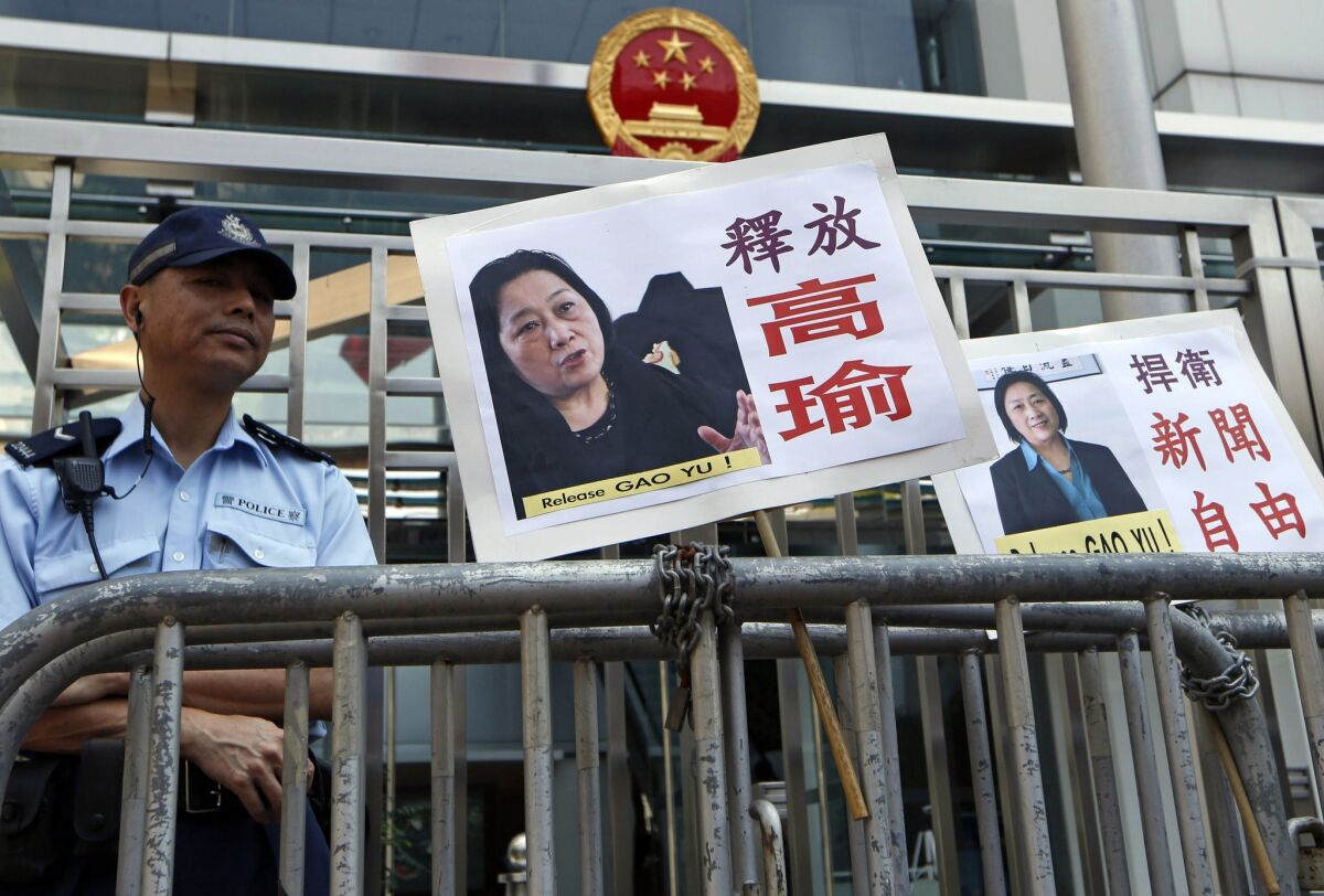 Signs with images of jailed veteran Chinese journalist Gao Yu placed by protesters outside tje Chinese government's liaison office in Hong Kong on Friday.